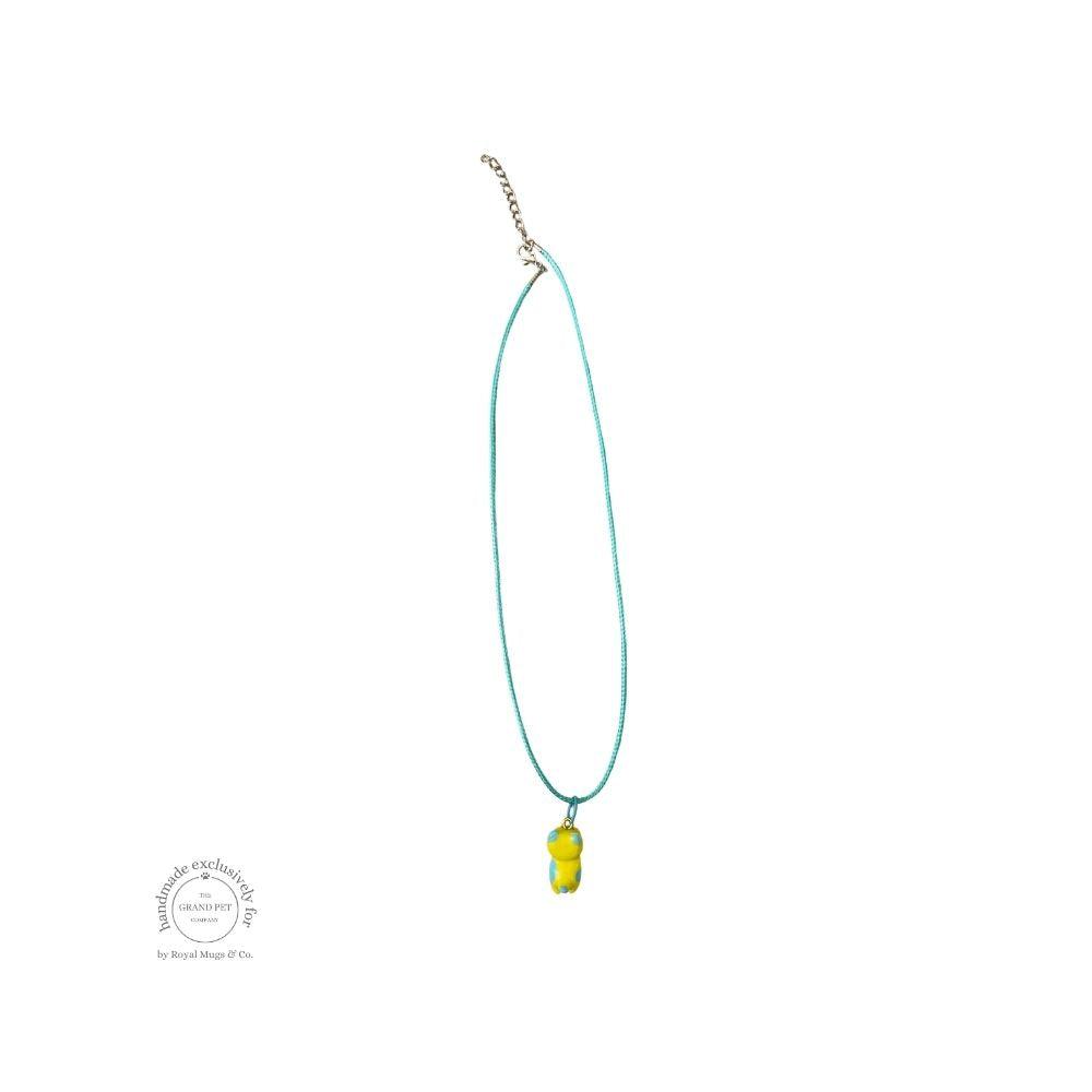 A yellow and orange dotted cat necklace with a lobster clasp.