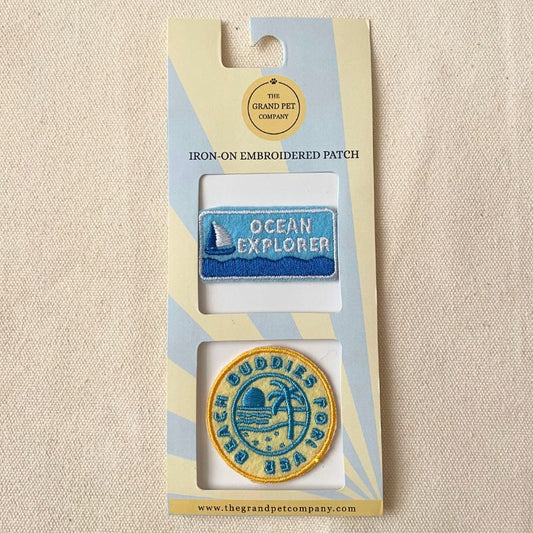 Two beach theme iron-on felt embroidered patches in packaging with 'Ocean Explorer' and 'Beach Buddies Forever' designs.