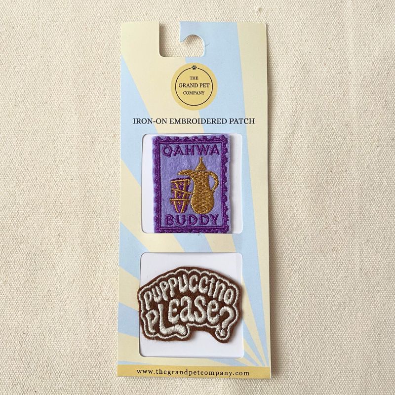 Two colourful iron on embroidered felt patches with coffee theme on packaging with 'The Grand Pet Company' branding.