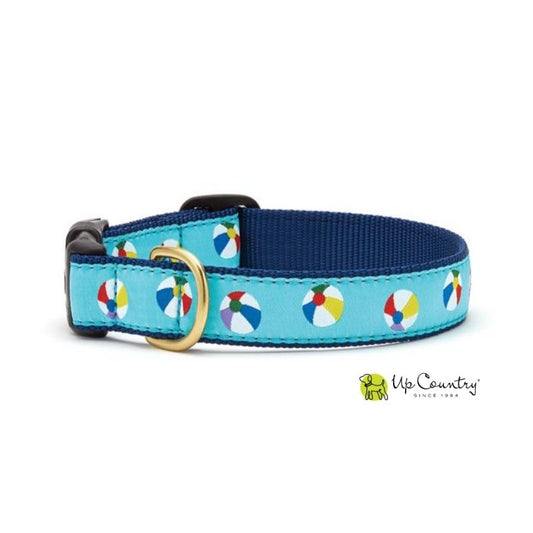 Dog collar with beach ball pattern on a blue background, brand 'Up Country' visible.