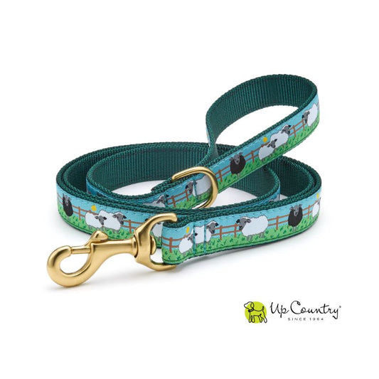 Dog leash with sheep pattern and gold clasp on a white background, featuring the 'Up Country' brand.