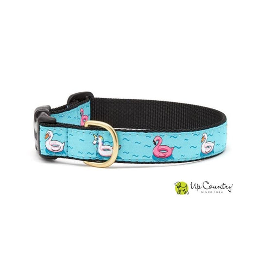 Dog collar with unicorn, duck and flamingo inflatables on a blue wave background on black webbing.