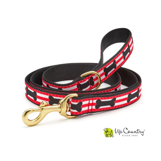 Dog leash with black bone pattern on red stripe background, gold clasp, and Up Country logo.
