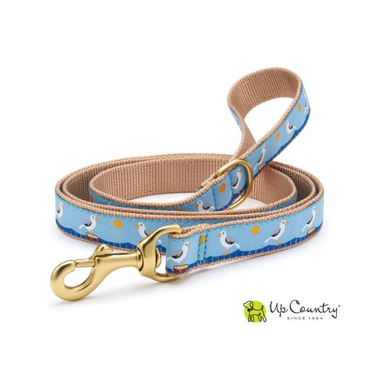 Dog leash with seagull pattern on a blue background and gold clasp on a white background, featuring the 'Up Country' brand.