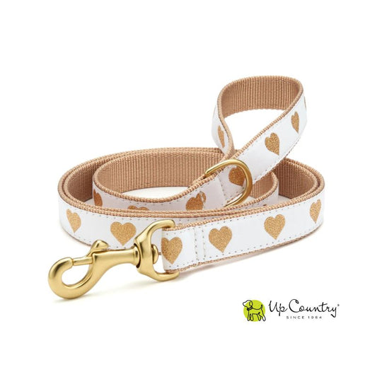 Dog leash with gold heart pattern and brass clasp on a white background, featuring the 'Up Country' brand.